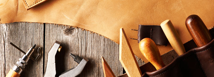 Leather Crafting Tools on Wooden Table with Brown Leather
